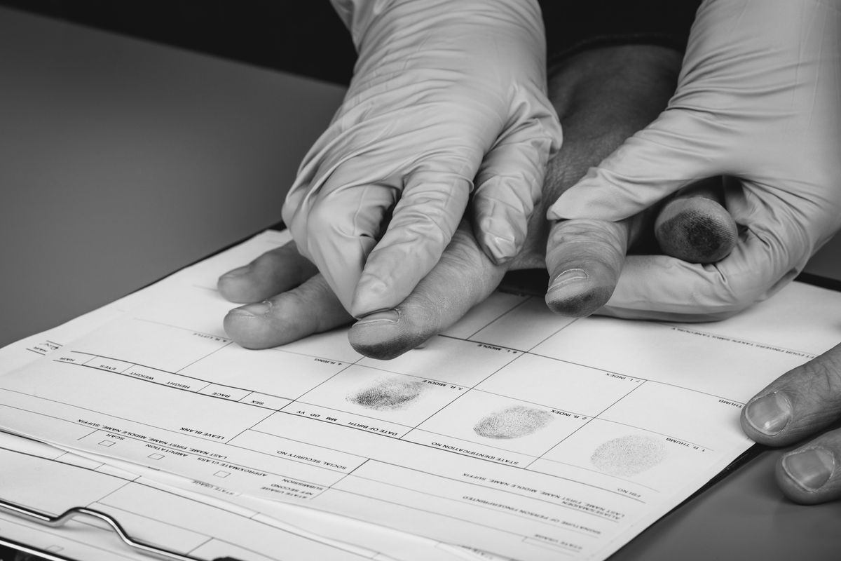 police takes fingerprints of a criminal. law concept.